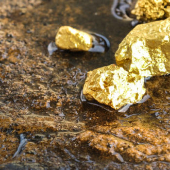 The pure gold ore found in the mine on a stone floor